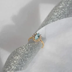 Bague or 375 2 tons fleur topaze bleue traitée ovale et zirconias