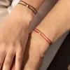 Bracelet or 750 jaune diamant 0.1 carat cordon rouge