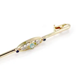 Broche d'occasion or 750 jaune doublet grenat verre zirconias